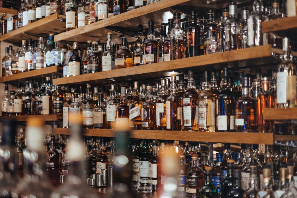 Shelves full of liquor bottles in a bar.