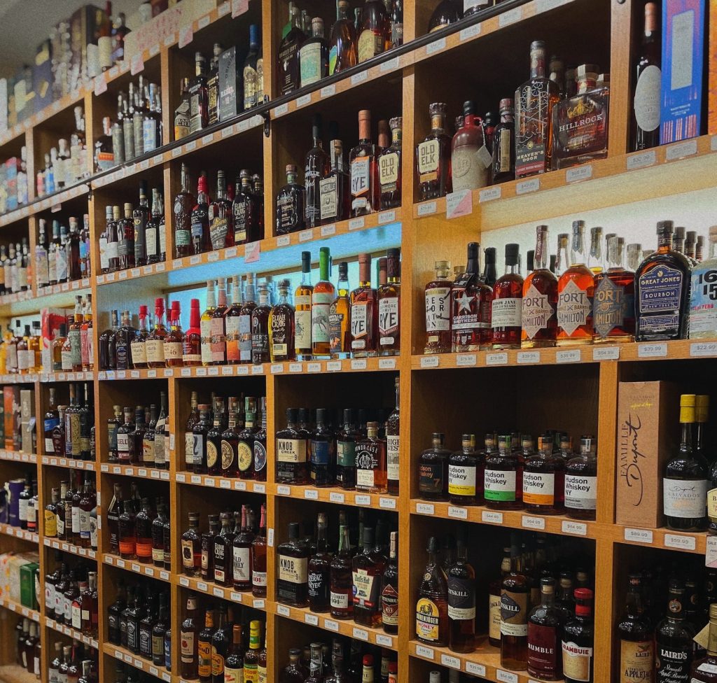 Picture of whiskey on shelves in a shop. Credit Stephen Ventura via Unsplash