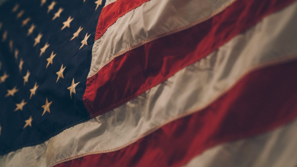 Picture shows the American Flag. Credit to Samuel Branch via Unsplash